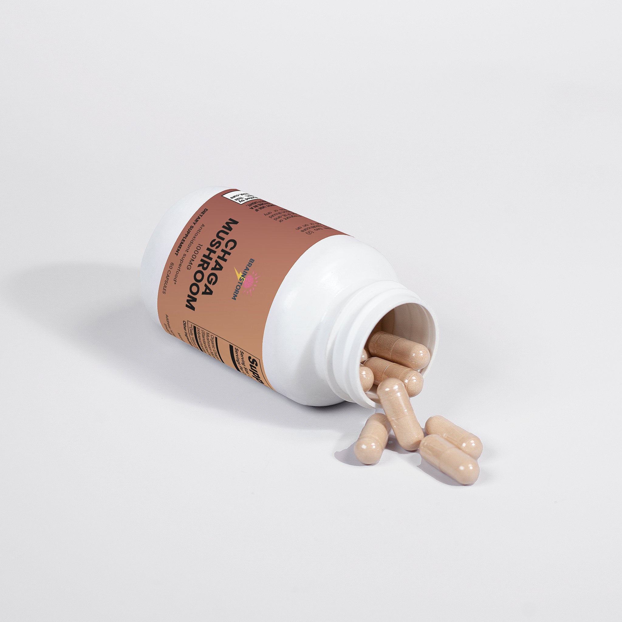 Brainstorm Chaga Mushroom Supplement bottle with pills spilling out on a white background