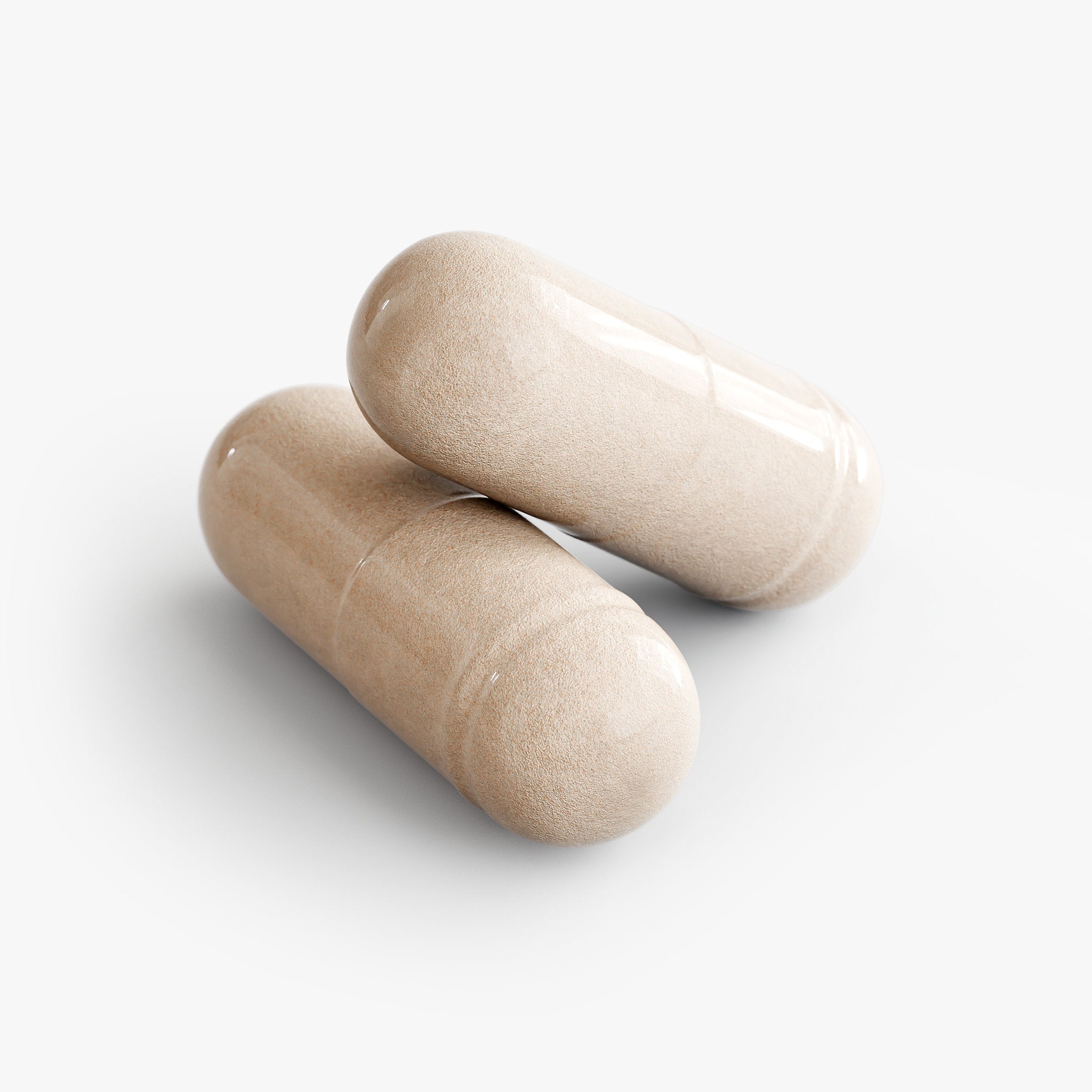 Two beige sea moss capsules on a white background