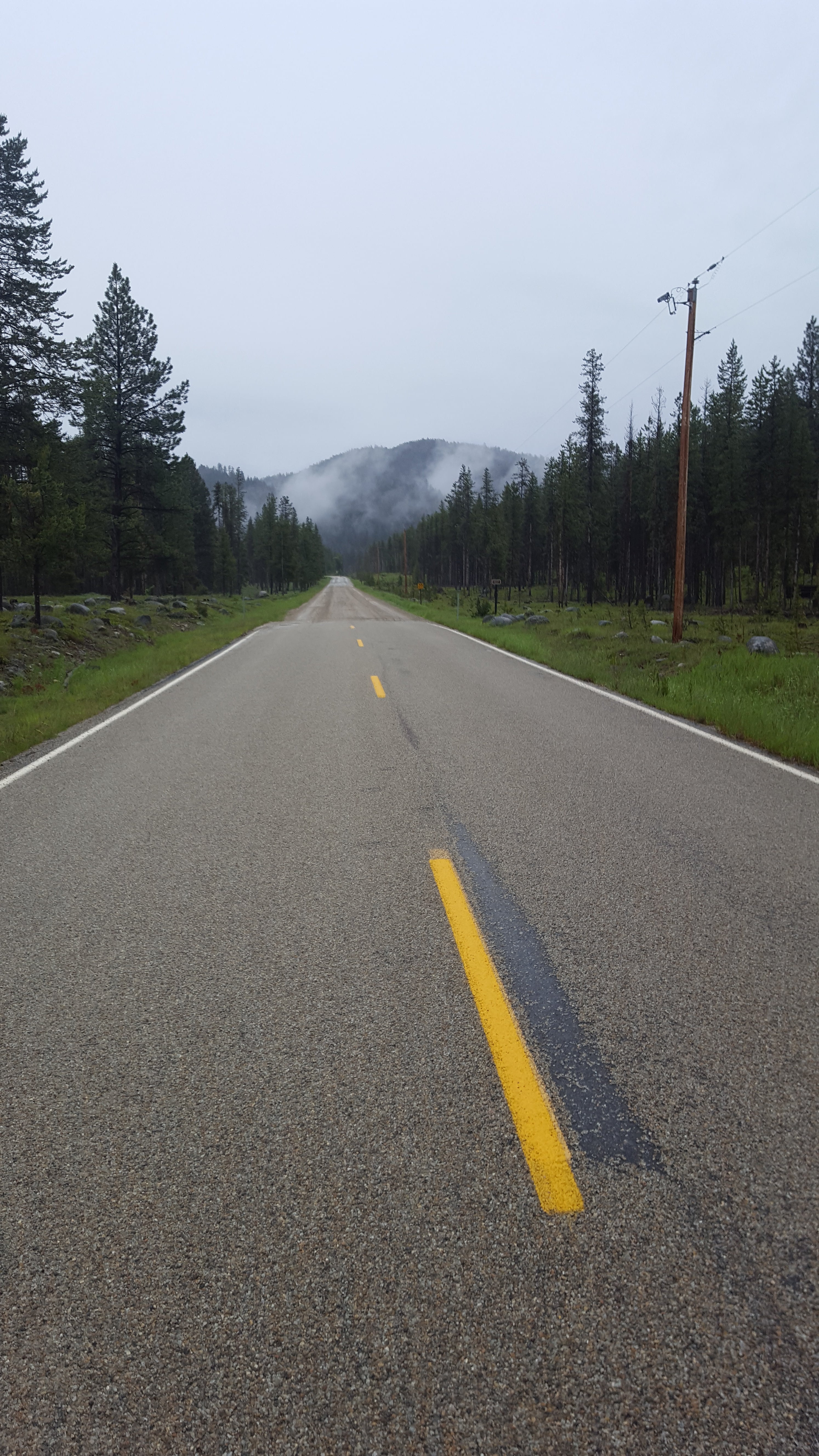 Winding road with a yellow line in a mountainous area 